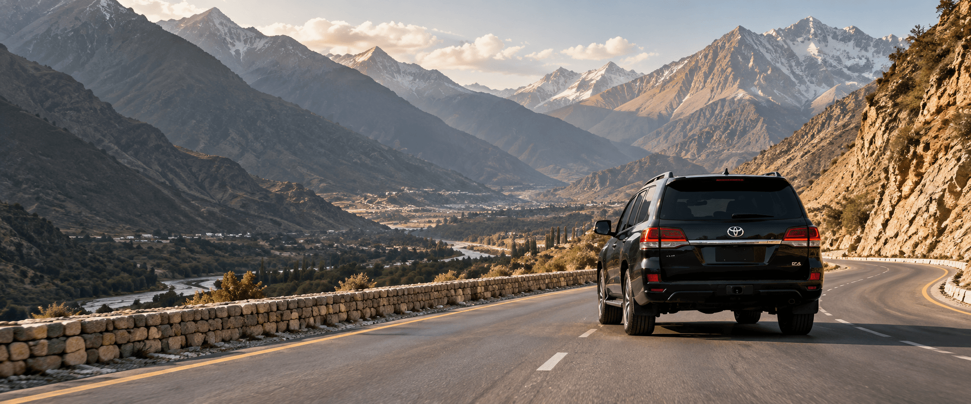 A Land Cruiser travelling along a scenic mountain road in northern Pakistan